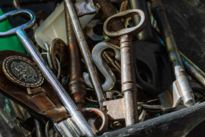 Jumbled collection of old keys, rusted golds, coppers, silvers mixed in a box.